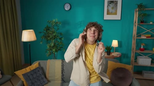 Young Adult Dances to Music at Home