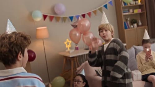 Children Celebrate Birthday with Balloons and Party Hats