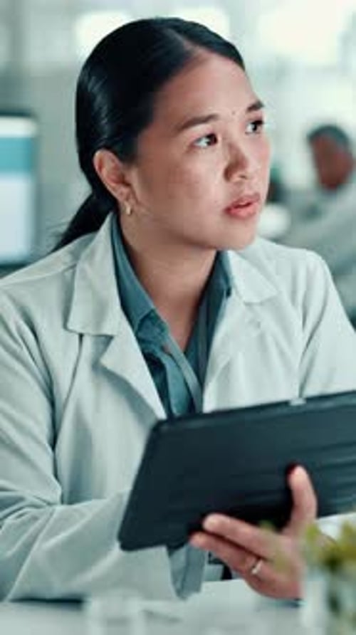 Woman Researcher Viewing Tablet in Laboratory