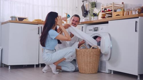 Couple Doing Laundry Together at Home