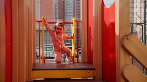 Young Child Engaging with Playground Equipment Demonstrating Joy and Playfulness in an Outdoor