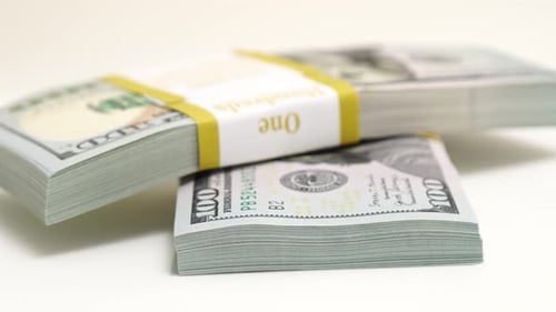 Stack of Bank Bundles with US Dollars on a White Background Closeup Shot of New Freshly Printed