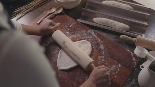 Chef use Rolling pin on dough