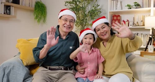 Family Waving and Wearing Santa Hats