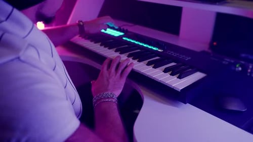 Musician Plays Electronic Keyboard in Studio