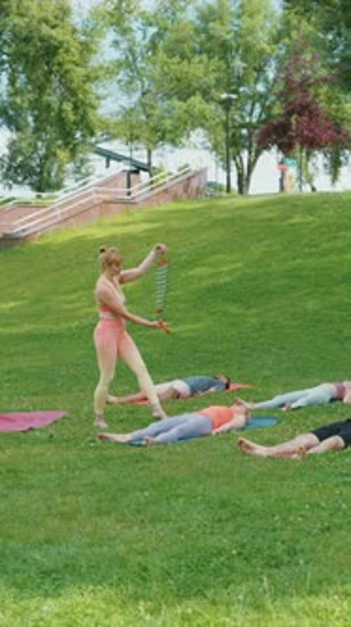 Yoga Class with Instructor in a Green Park