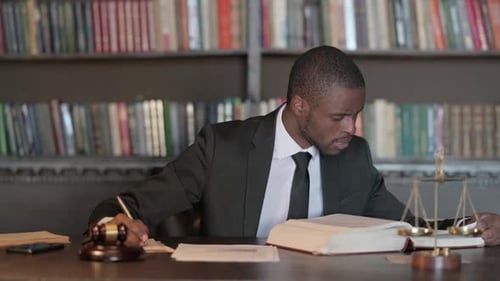 African Male Lawyer Working on Documents in Office