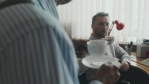Friendly Coworkers Enjoying Nice Tea during Break in Office