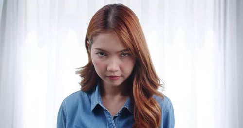 Smiling Woman with Auburn Hair in Bright Room