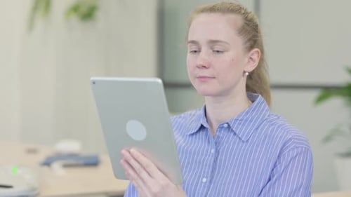 Woman Using Tablet Device in Office Setting