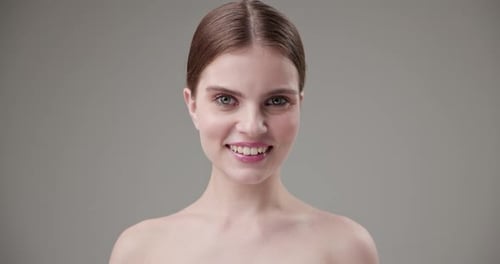 Woman Smiles and Talks to Camera in Studio