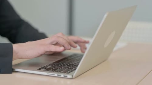 Close up of Businessman Typing on Laptop