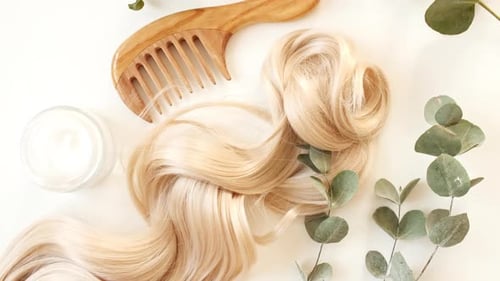 Blond Shiny Wavy Hair on White Background Shiny Woman Hair Strand Curl Hair Care and Beauty Salon