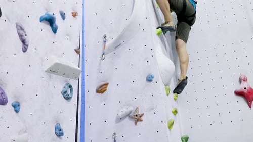 Young Man Climbing A Rock Wall