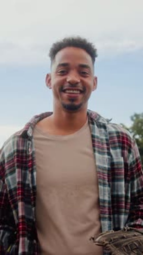 Young Black Man Playing Baseball While Looking at Camera
