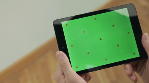 Male Hand Holding Digital Tablet Pc with Green Screen. Man Reading Ebook