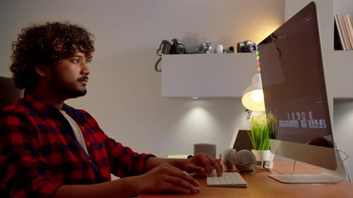 Video Editor Working at Computer Workstation