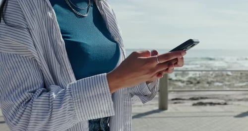 Phone, hands typing and woman at promenade for travel, vacation or text on holiday