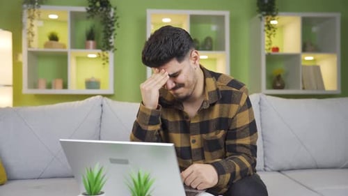 Unhappy and stressed young man crying.