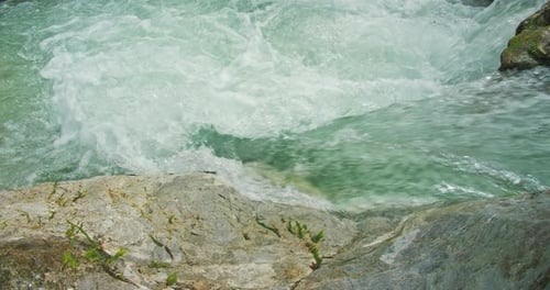Powerful stream of water moves very fast over rocks