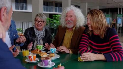 Elderly People Enjoying Breakfast in the Morning at Cafeteria Bar