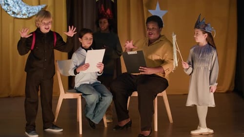 Theater Director And Child Actors During Rehearsal