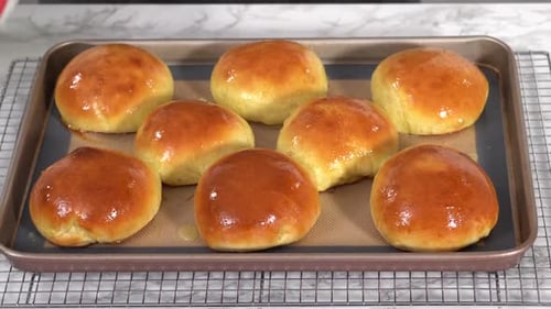 Golden Brown Bread Rolls on a Baking Sheet
