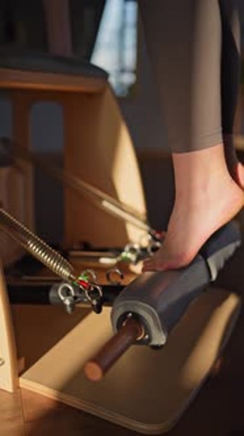 A Detailed Closeup of a Foot on a Balanced Body Chair Machine Illuminated By Sunlight