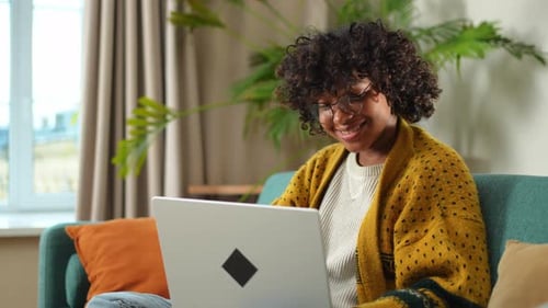 African American Girl Using Laptop at Home Office Looking at Screen Typing Chatting Reading Writing