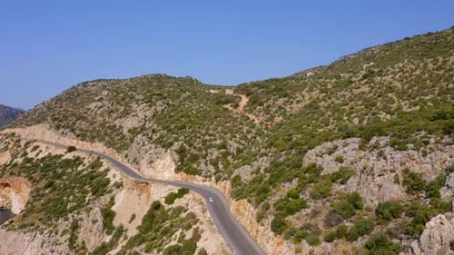 Aerial Drone View of Mountain Road with Driving Cars and Tropical Island