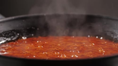 Red Sauce Simmering in a Black Frying Pan