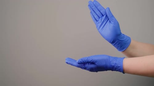 Doctor in latex gloves applause close-up. Unrecognizable medic show emotions using hands