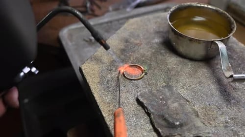 Gold Wedding Ring Making By Goldsmith Isolated Jeweler Melts Gold in Liquid State in Crucible Macro