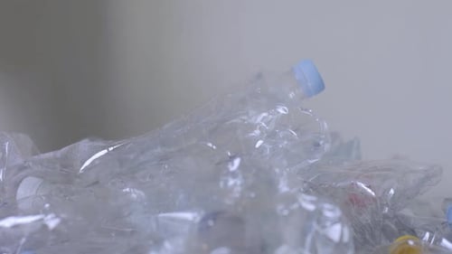 Close Up of Plastic Bottles and a Hand