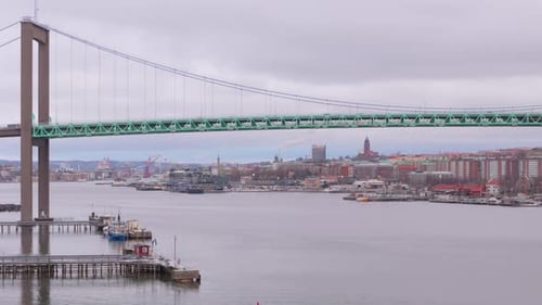 Aerial trucking shot reveals prominent Älvsborg suspension bridge in Gothenburg