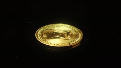 Eth Ethereum decentralized blockchain gold coin rotate around black background