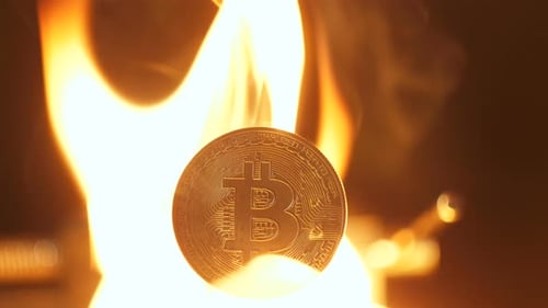 Closeup Bitcoin Burns and Falls Down Like Exchange Rates