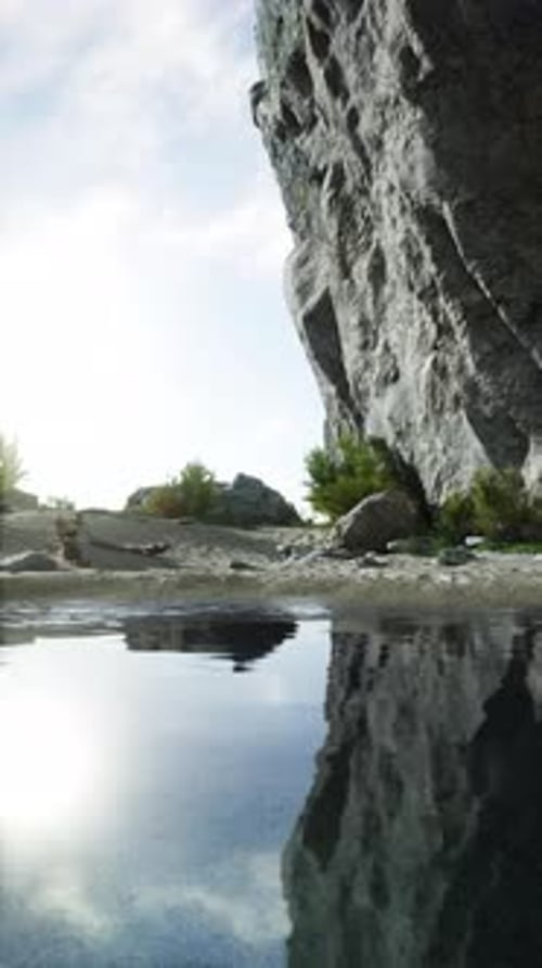 Majestic Rock Face Towering By Water