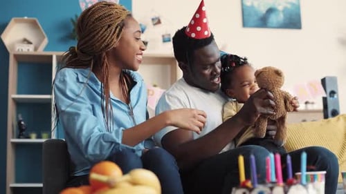Happy Family Celebrating Toddler's Birthday at Home