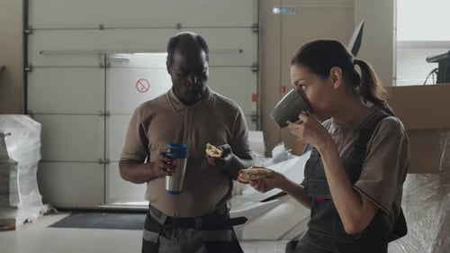 Workers Eating Lunch in Shipping Warehouse Mid Shot
