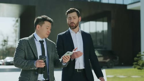 Young Attractive Business Men Walking Talking Discussing on Street in Modern City Near Business