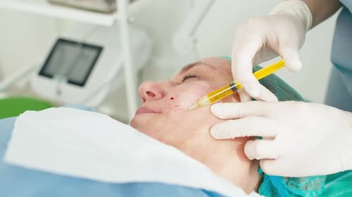 Woman Receiving Facial Injection in Hospital Room