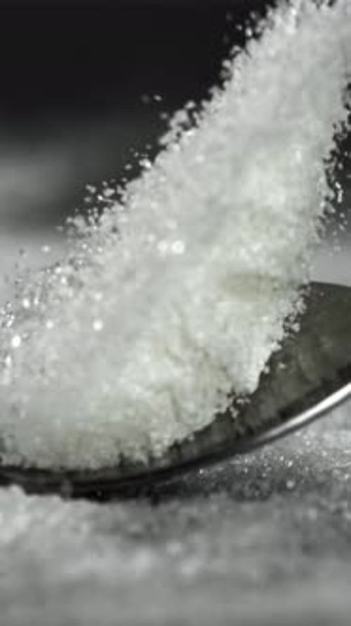 A Spoonful of Sugar Falls on the Table Filmed on a Highspeed Camera at 1000 Fps