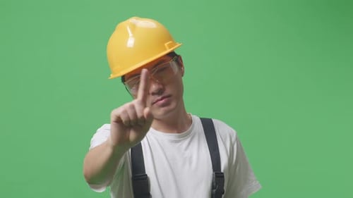 Man Worker Wearing Safety Helmet Pointing And Disapproving With No Index Finger Sign On Green Screen