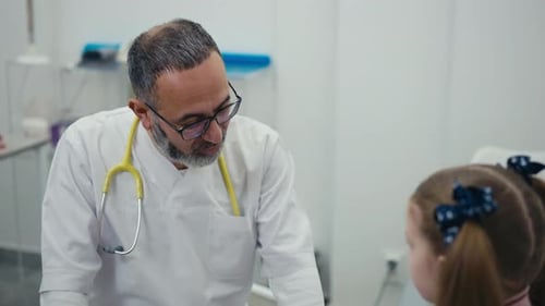 Doctor Talking to Young Patient in Clinic