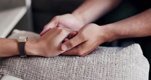 Holding hands, love and support with people in home together for emotions, grief or loss