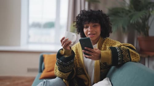 Close Up Young Woman with Phone Drink Tea African American Woman Hold in Hand Use Mobile Phone Drink