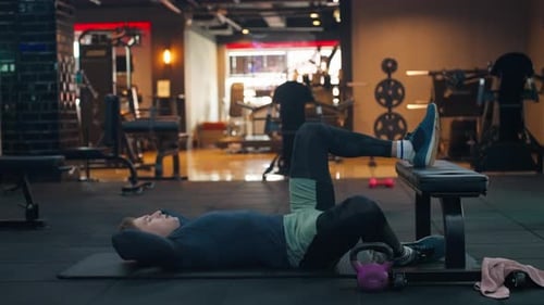 Young Adult Man Doing Crunches in Gym