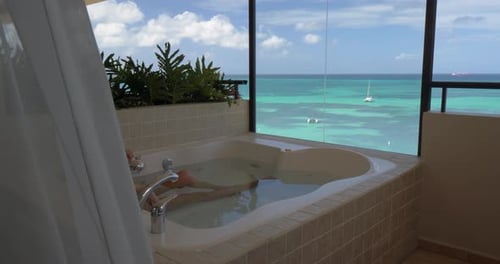 Beautiful Woman in Hot Tub Overlooking Tropical Ocean Alone