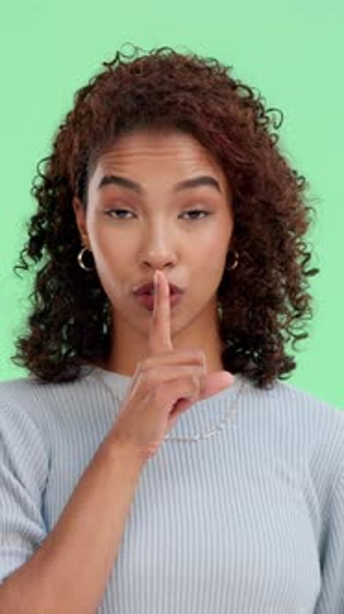 Face, silence and woman on green screen for secret, privacy and confidential in studio